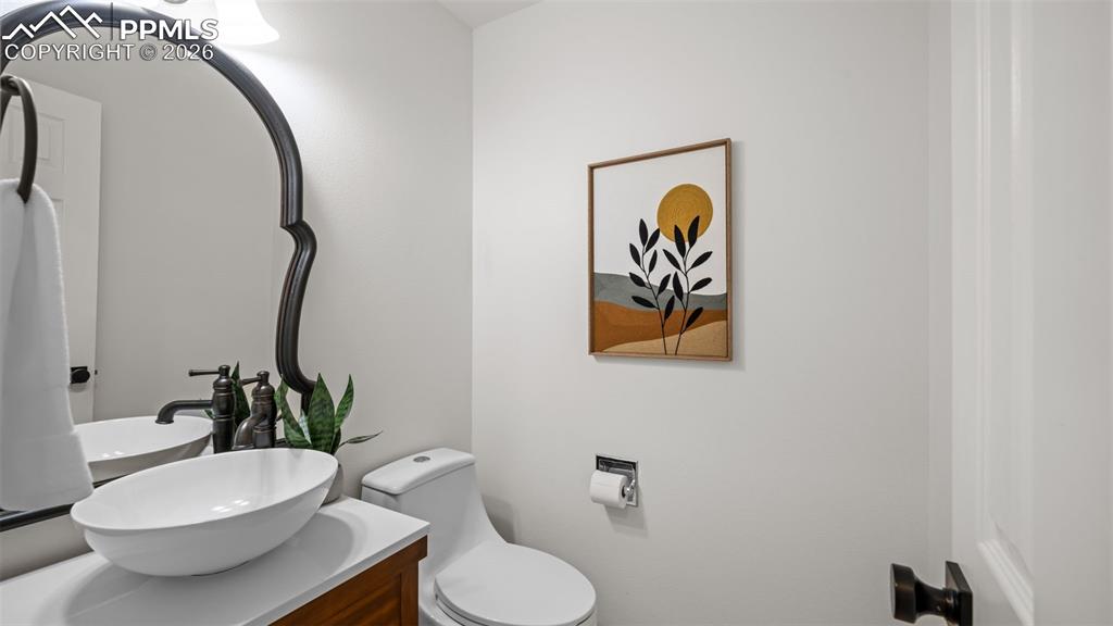 Half bath featuring toilet and vanity