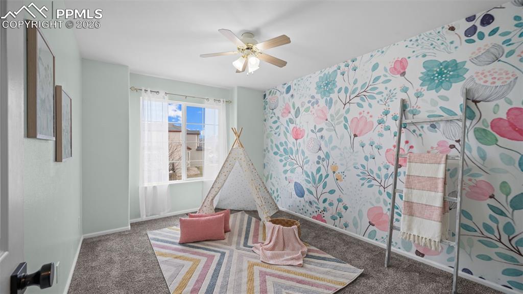 Rec room featuring carpet and a ceiling fan