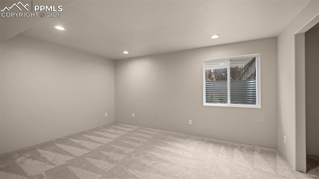 Empty room featuring light colored carpet and recessed lighting