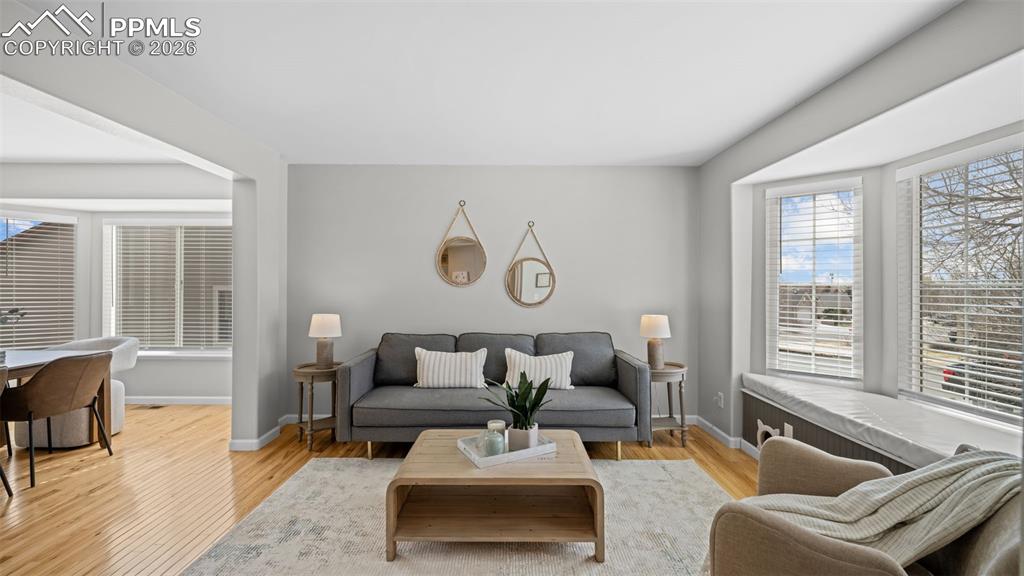 Living area with light wood finished floors and baseboards