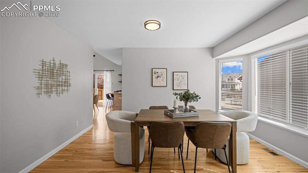 Dining area with light wood-style flooring and baseboards