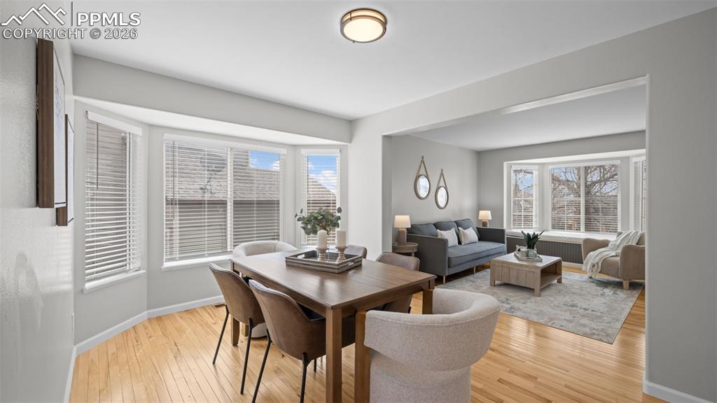 Dining space featuring light wood-style floors and healthy amount of natural light