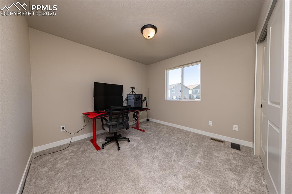 Office featuring light carpet and baseboards