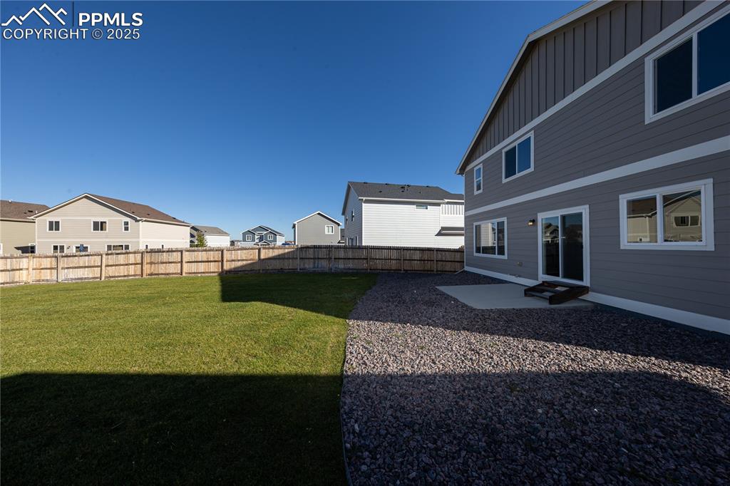 Fenced backyard with a patio and a residential view