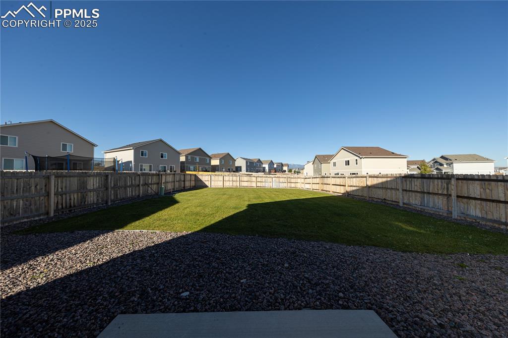 Fenced backyard with a residential view