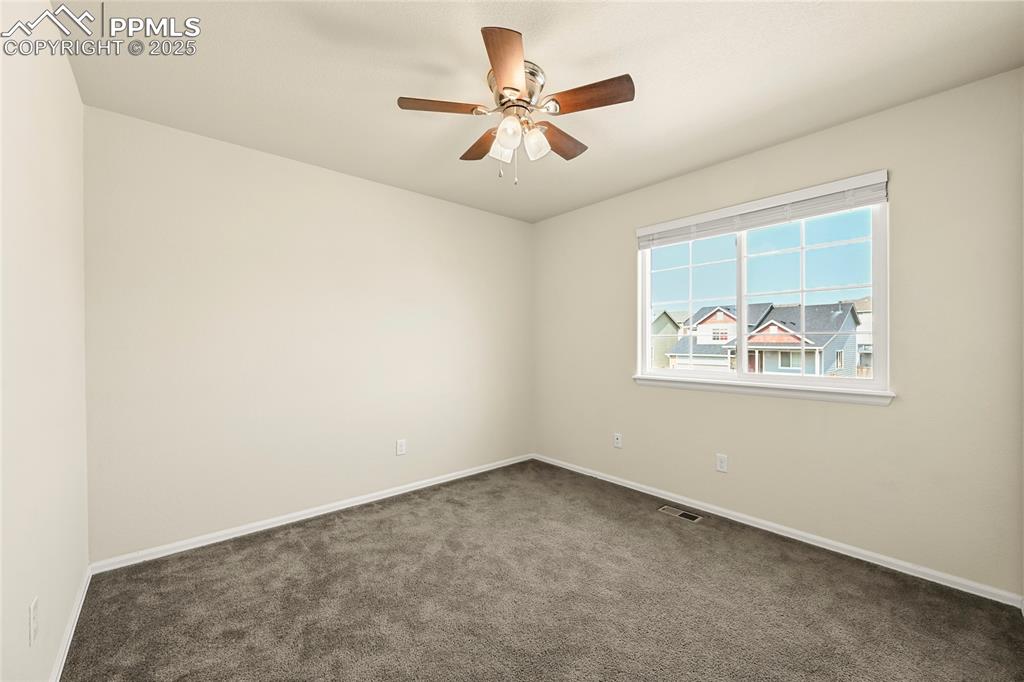 Spare room with carpet floors and ceiling fan