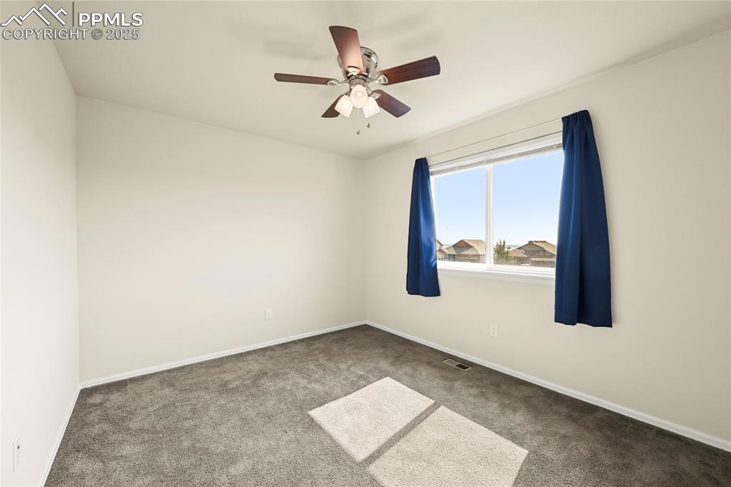 Spare room with carpet flooring and ceiling fan