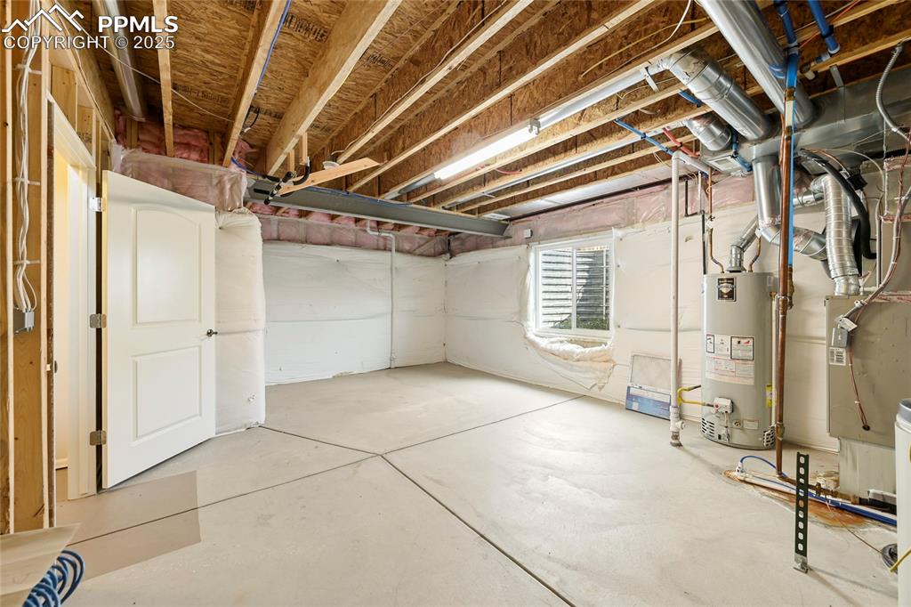 Basement featuring water heater and heating unit