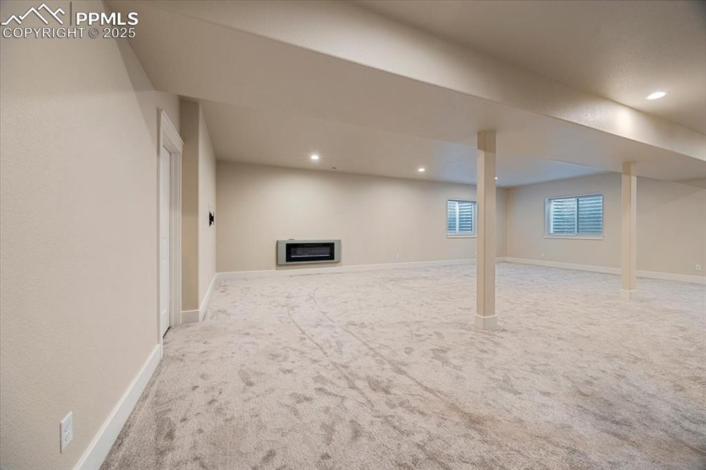 Below grade area featuring baseboards, recessed lighting, and carpet flooring