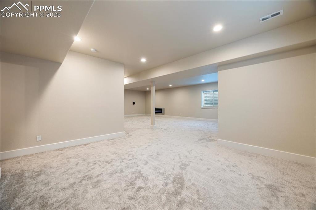 Basement featuring recessed lighting, visible vents, and light colored carpet