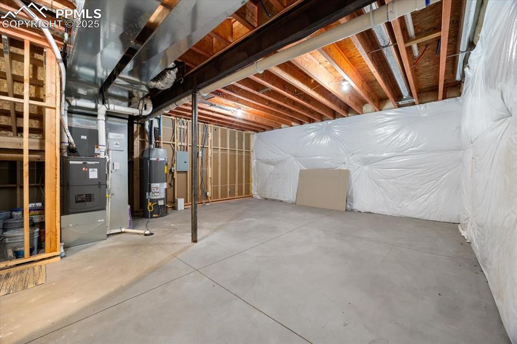 Unfinished basement with water heater and heating unit