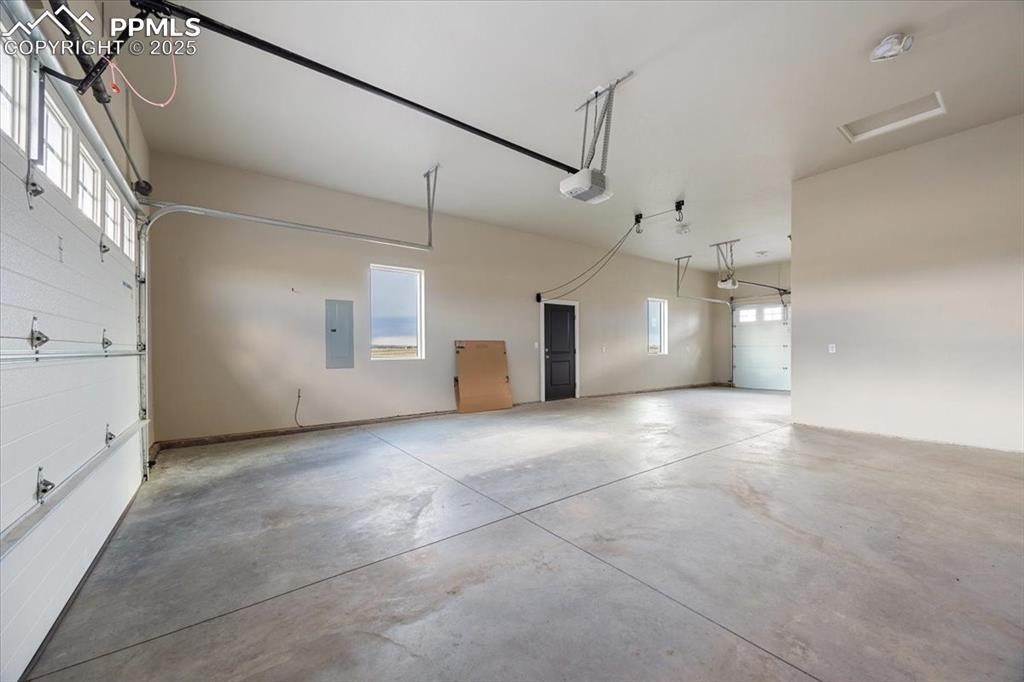 Garage with a garage door opener and electric panel