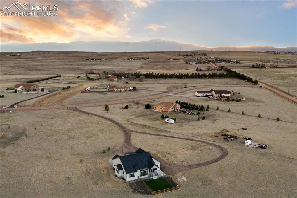 Birds eye view of property with a rural view and view of desert