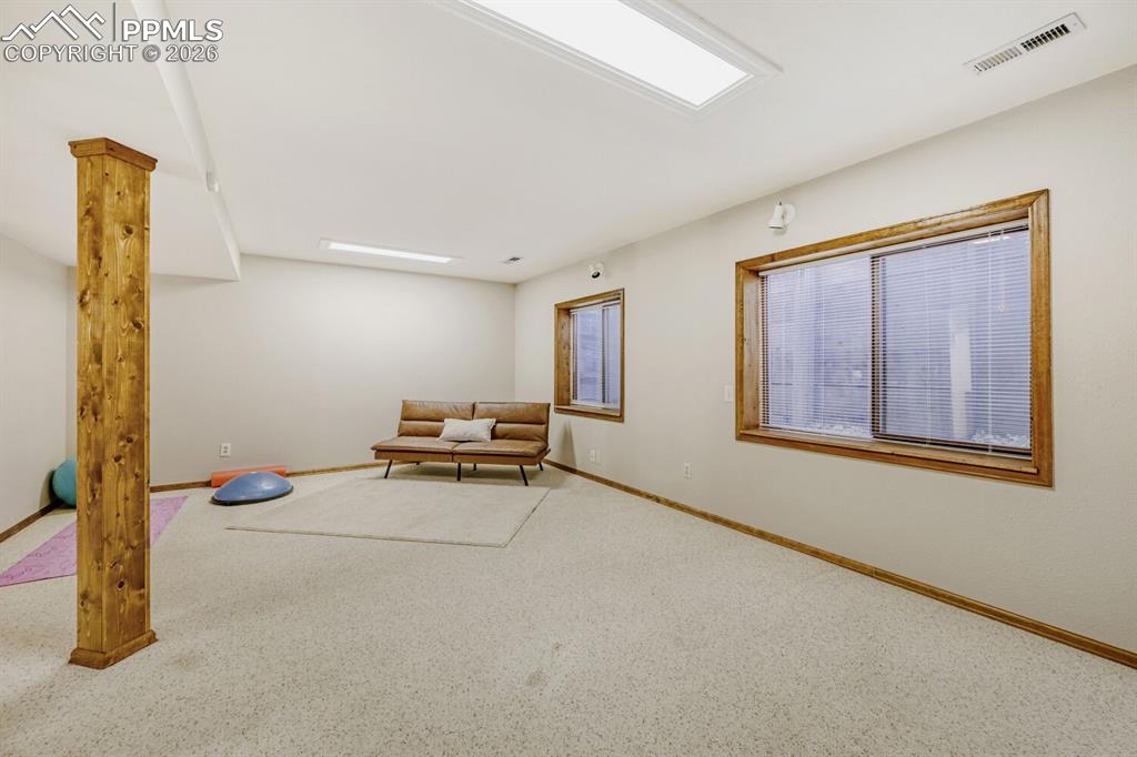 Sitting room featuring carpet floors and baseboards