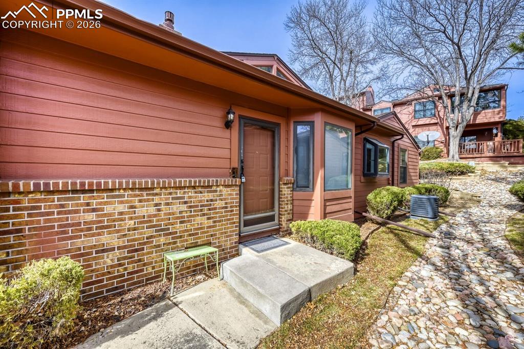Property entrance featuring brick siding