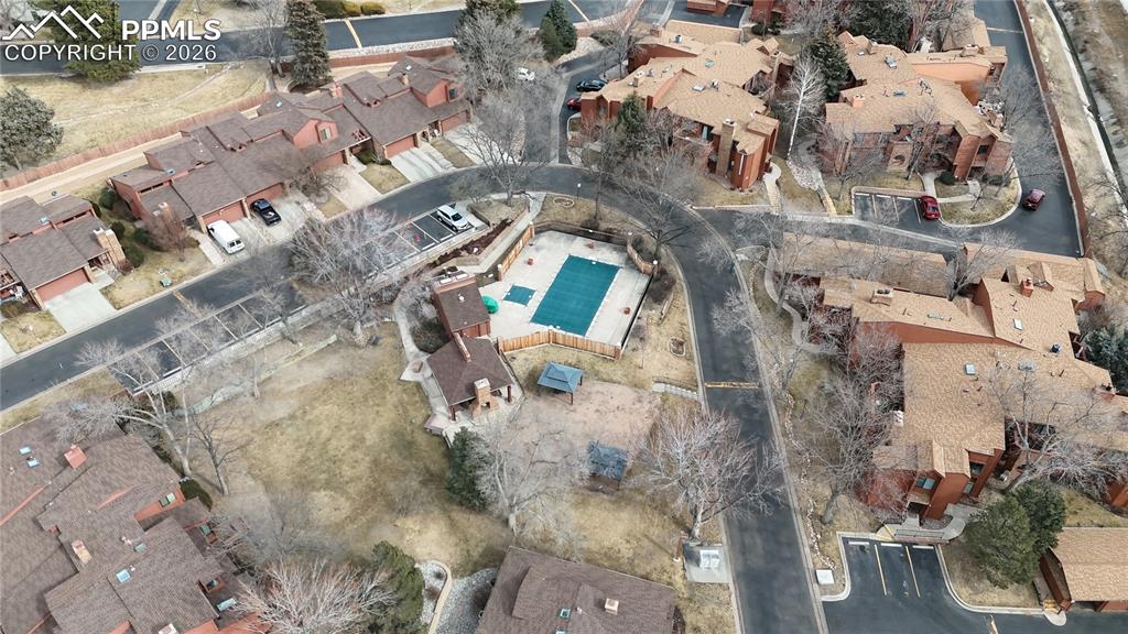 Aerial view of property's location featuring nearby suburban area and a pool