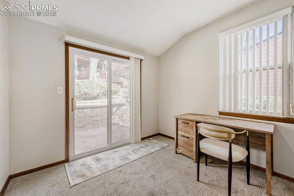 Carpeted office space with baseboards