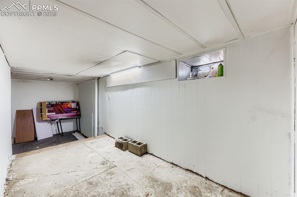 Below grade area featuring wood walls