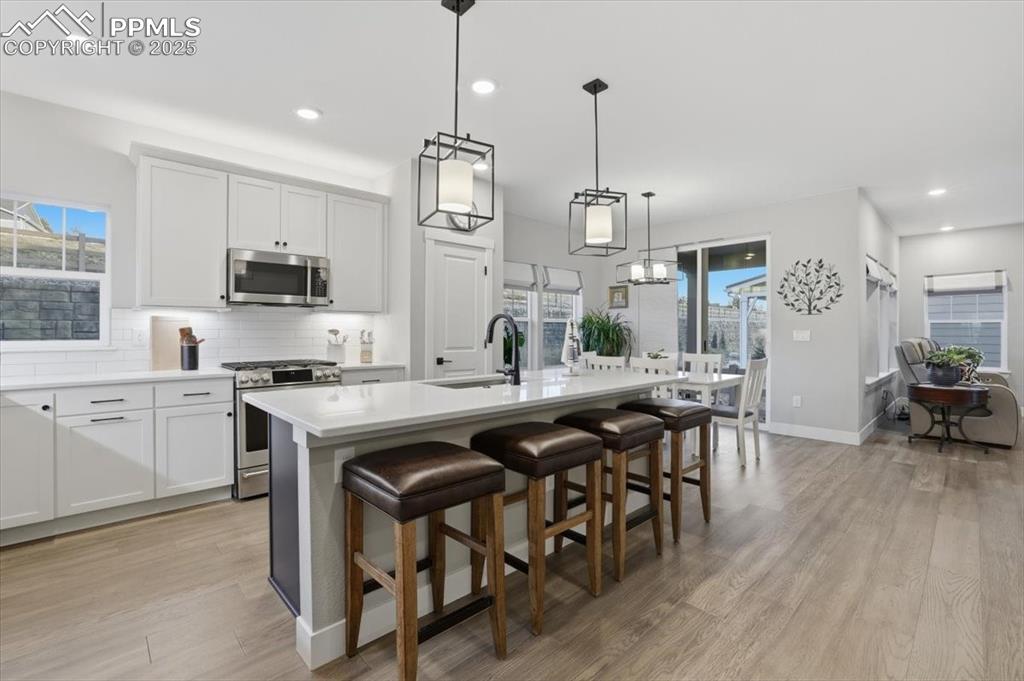 The kitchen has quartz countertops, bar seating and stainless steel appliances.