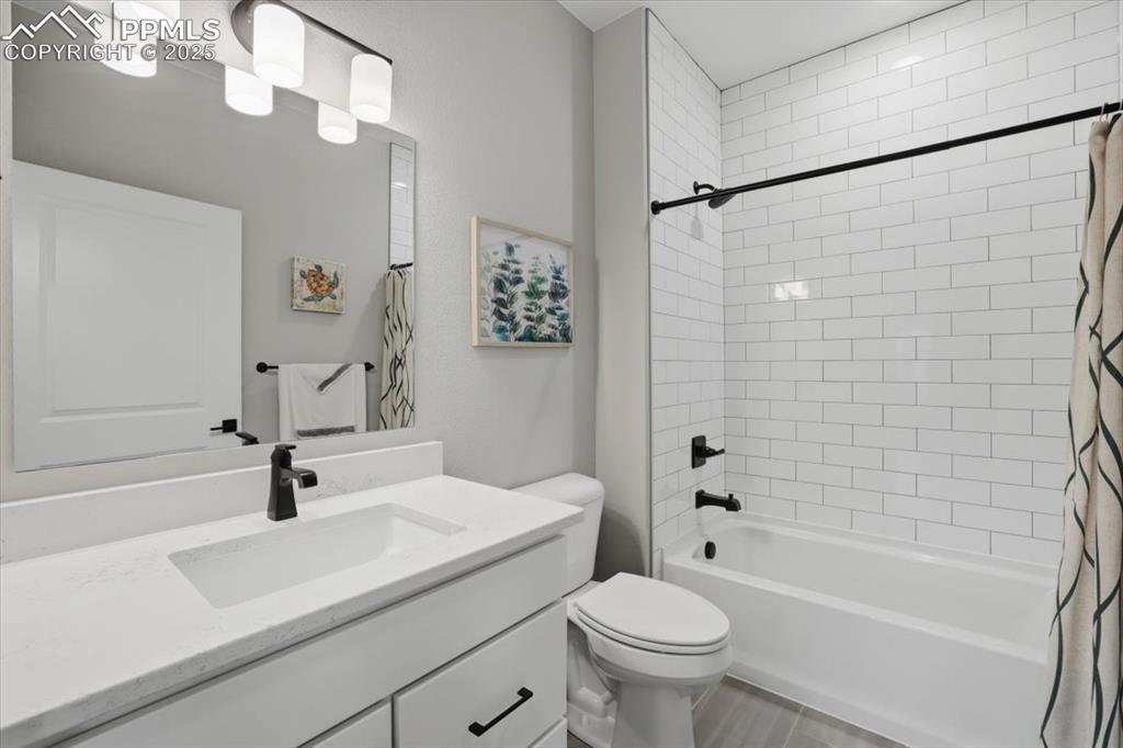 This pretty second main-floor full bath has a tub/shower combo and a quartz countertop.