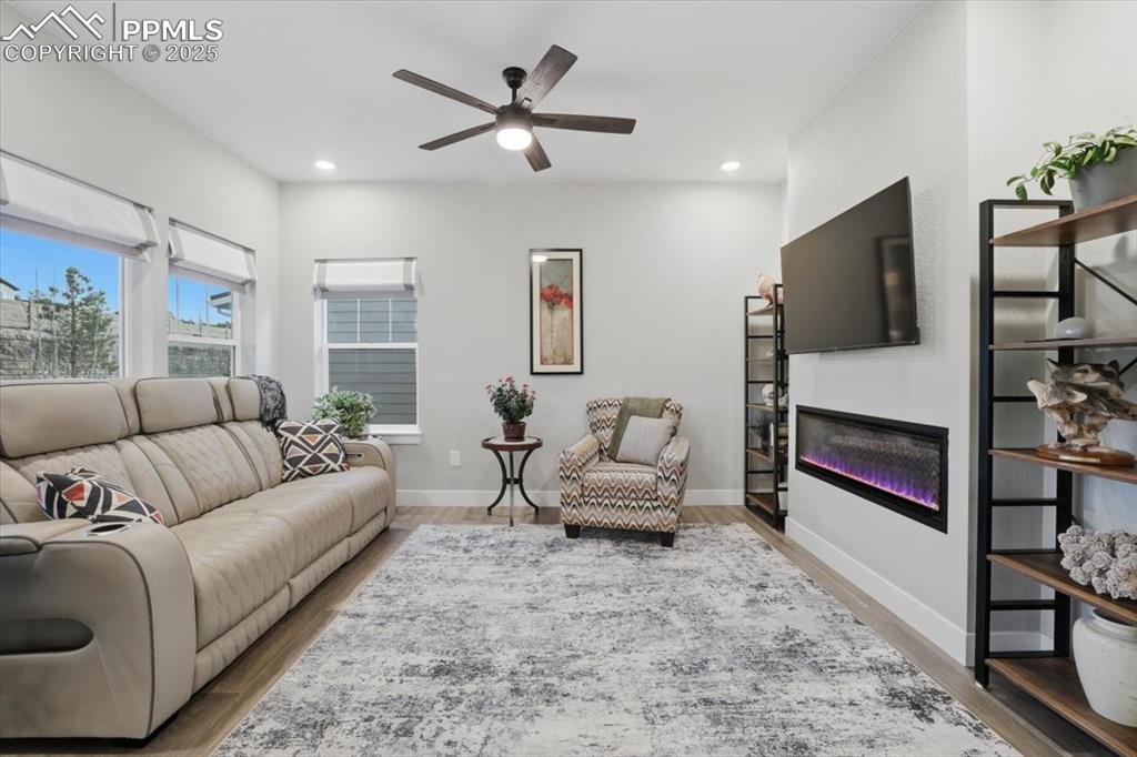 The living room has plenty of windows for natural light and warmth from the gas fireplace.