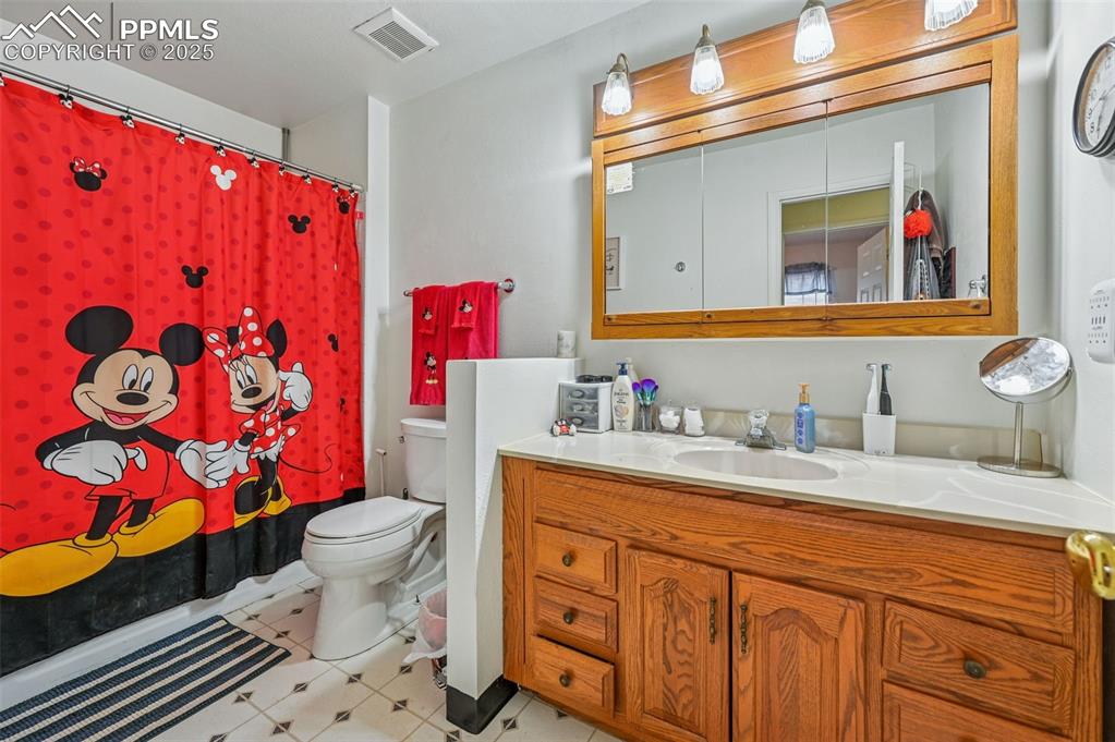 Full bathroom featuring vanity and shower / tub combo with curtain