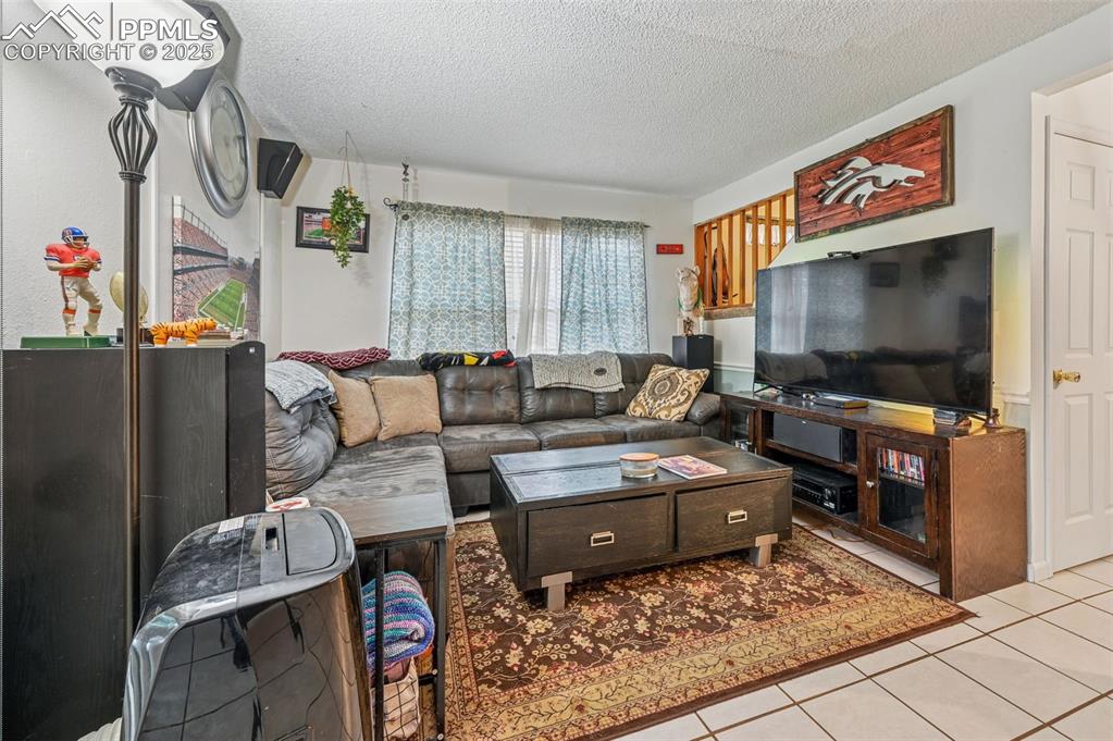 Tiled living area with a textured ceiling