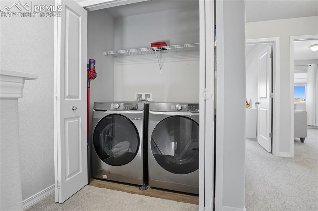 LAUNDRY AREA (WASHER AND DRYER INCLUDED) WITH HOOKS AND SHELVES FOR PROPER STORAGE.