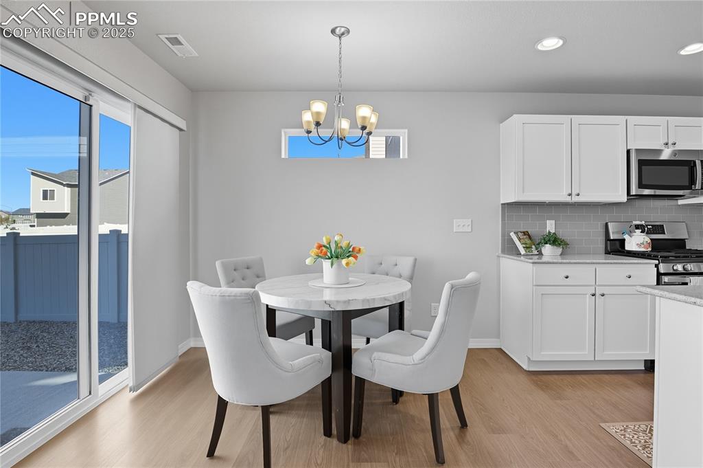 DINING AREA WALKS-OUT TO THE SPACIOUS, FENCED BACKYARD