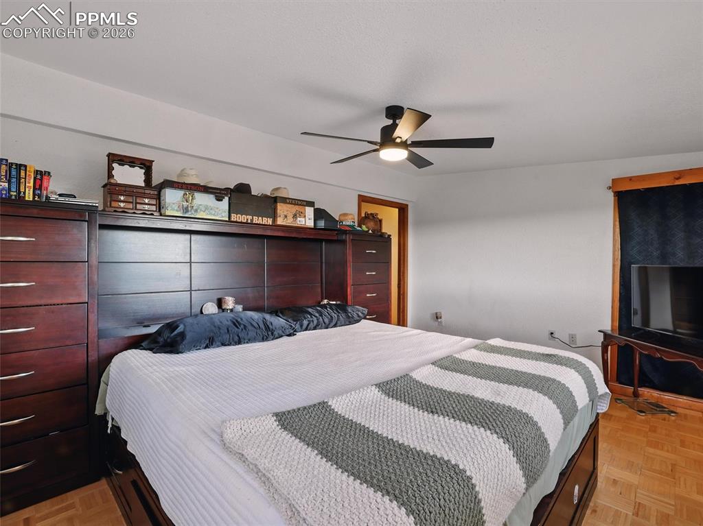 Bedroom featuring parquet flooring and ceiling fan