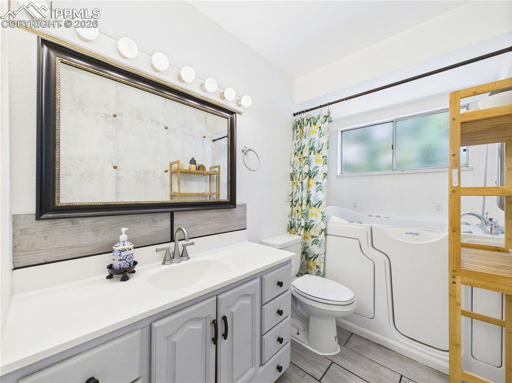 Full bathroom with a bath and vanity