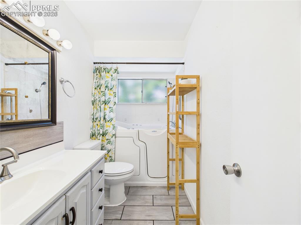 Bathroom featuring vanity and a bath