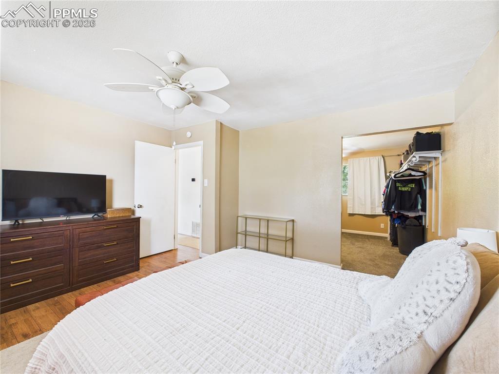 Bedroom featuring a closet, a ceiling fan, and light wood-style floors