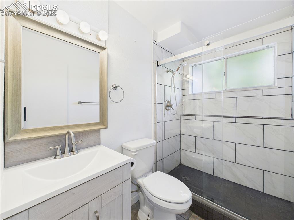 Full bath with vanity and a stall shower