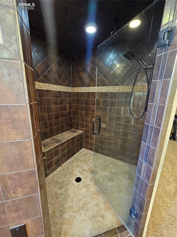 Full bath with a shower stall and recessed lighting
