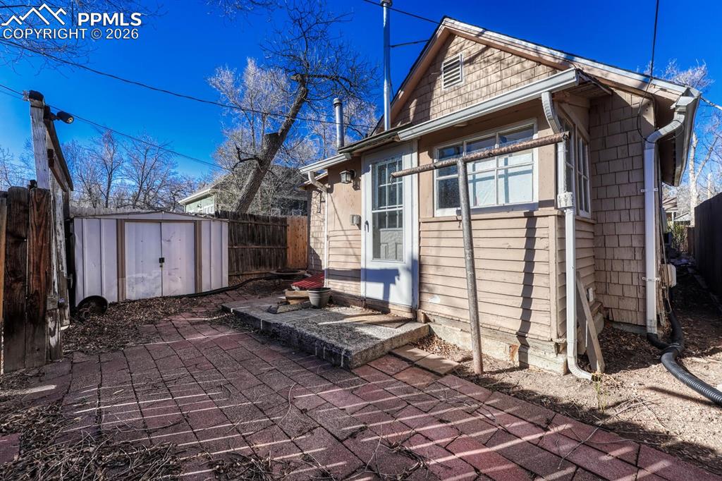 Fenced back yard includes shed