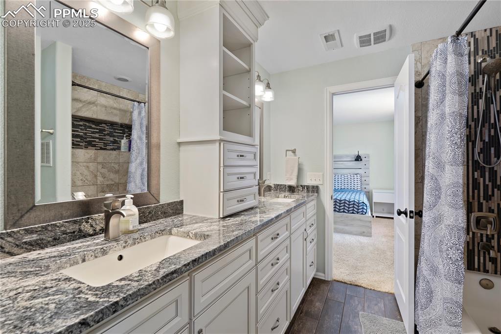 En suite Lower Primary Bath w/granite double sinks and high-end cabinets!