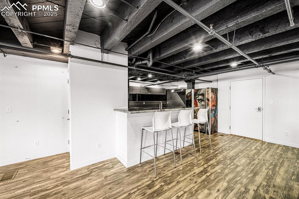 Kitchen featuring wood finished floors and breakfast bar