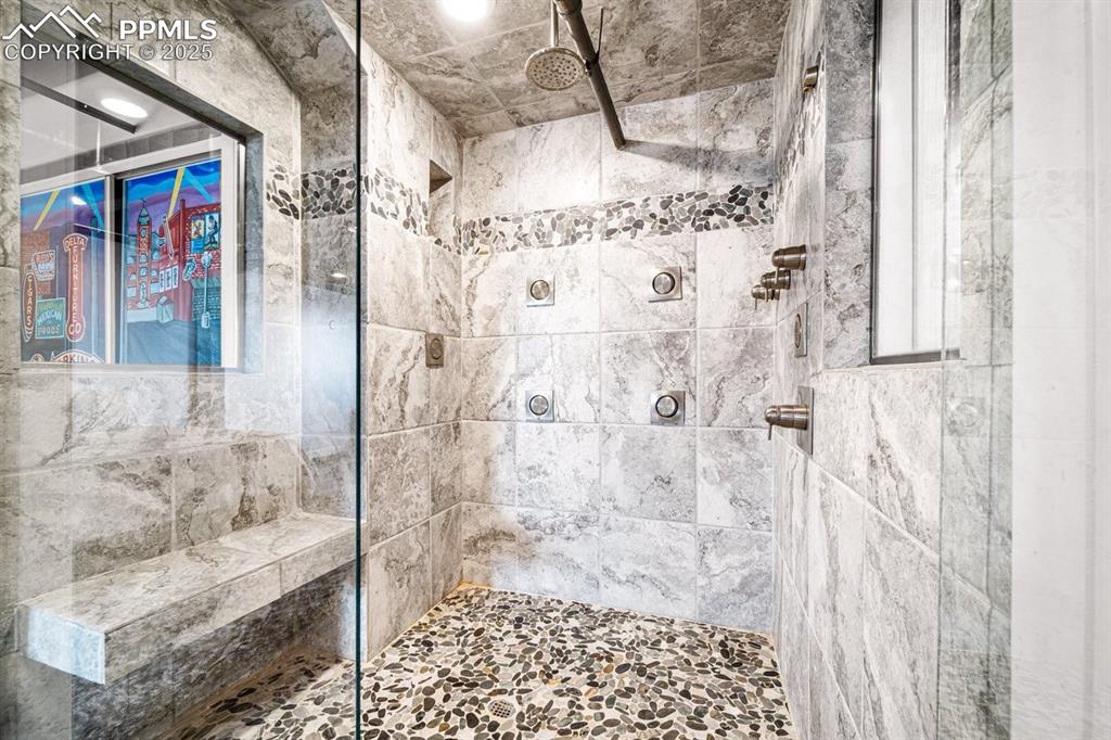 Bathroom featuring a tile shower