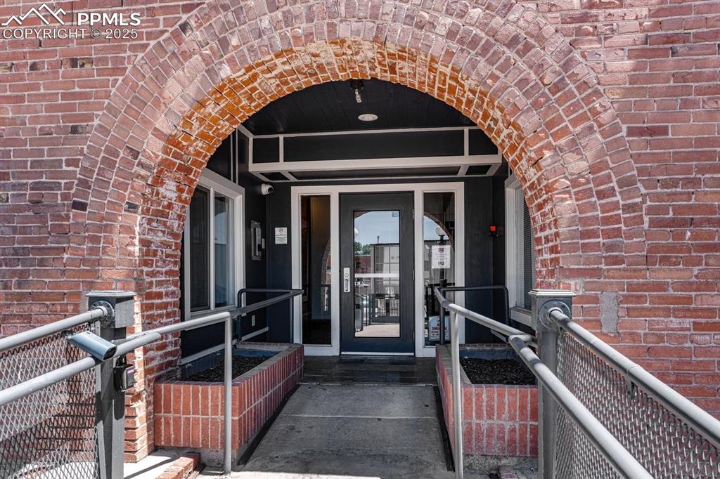 Property entrance featuring brick siding