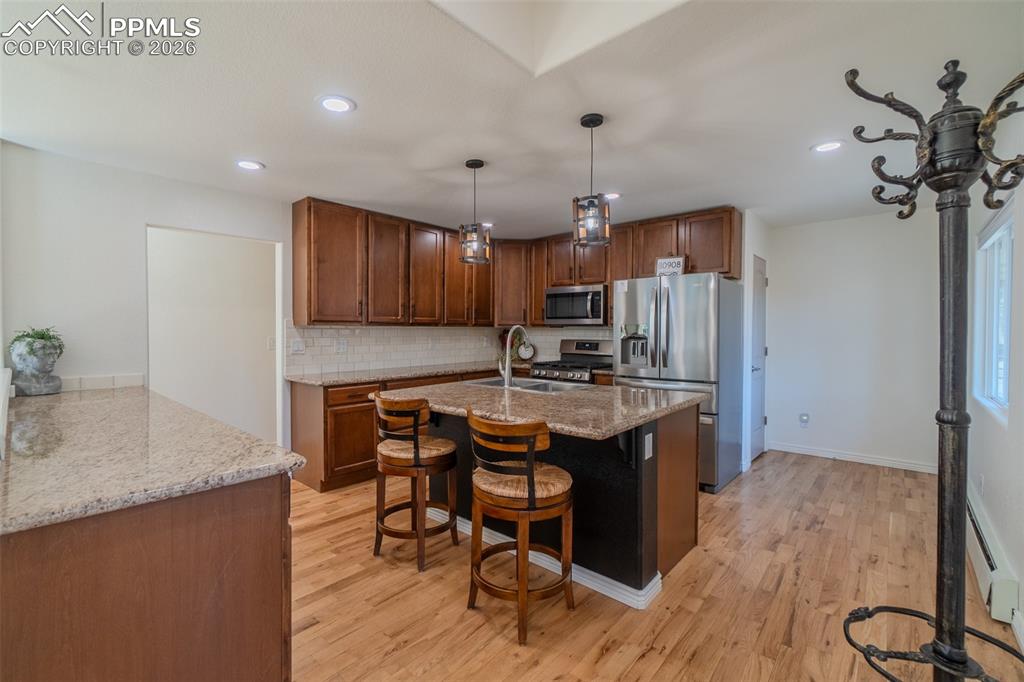 Kitchen featuring open concept with pantry, island and plenty of storage space 