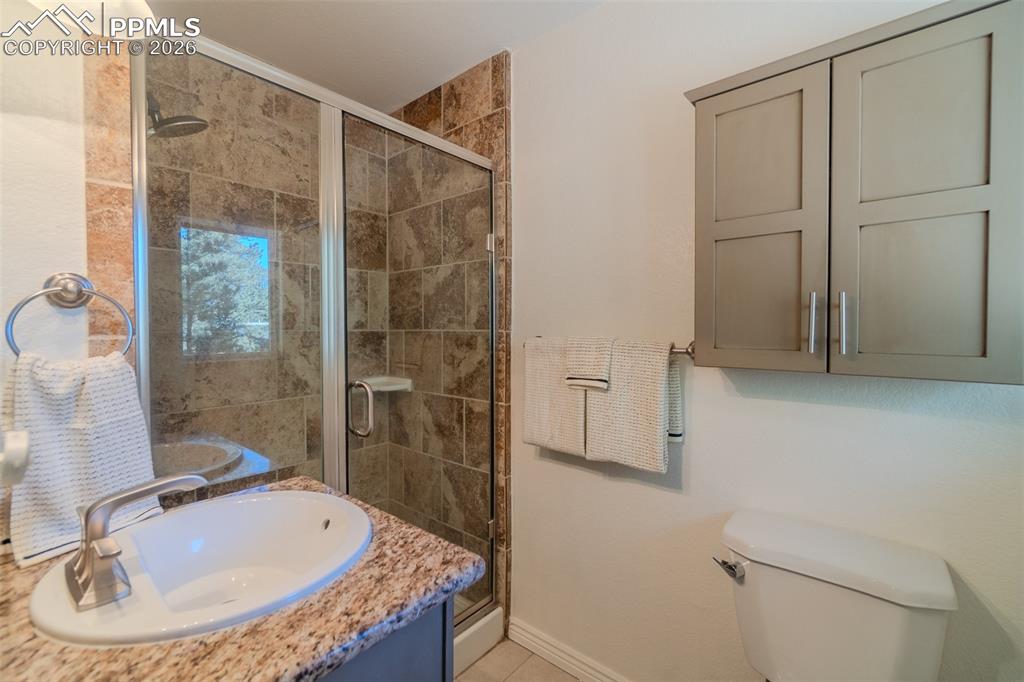 Primary Bathroom with a shower stall and vanity
