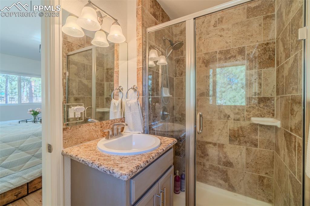 Bathroom featuring vanity and a stall shower