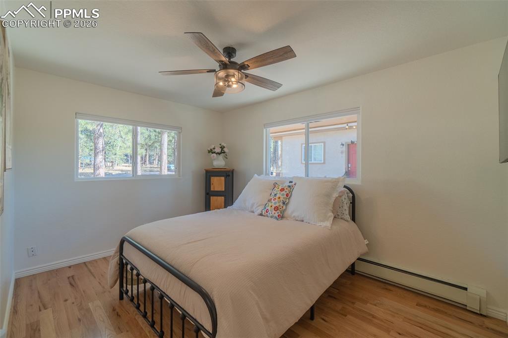 Bedroom on main level with ceiling fan
