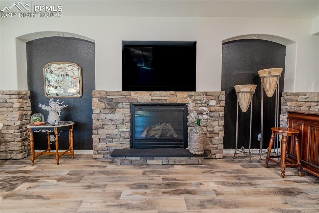 Living room with wood finished floors and a gas fireplace