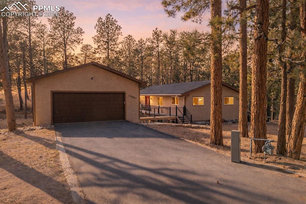 View of front of property featuring a 2 car garage, with sealed driveway
