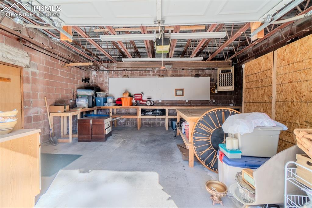 Garage featuring a heating unit, painting bay and tons of counters and storage! 
