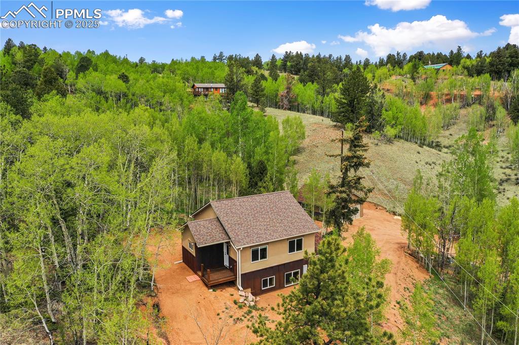 View from above of property with a heavily wooded area