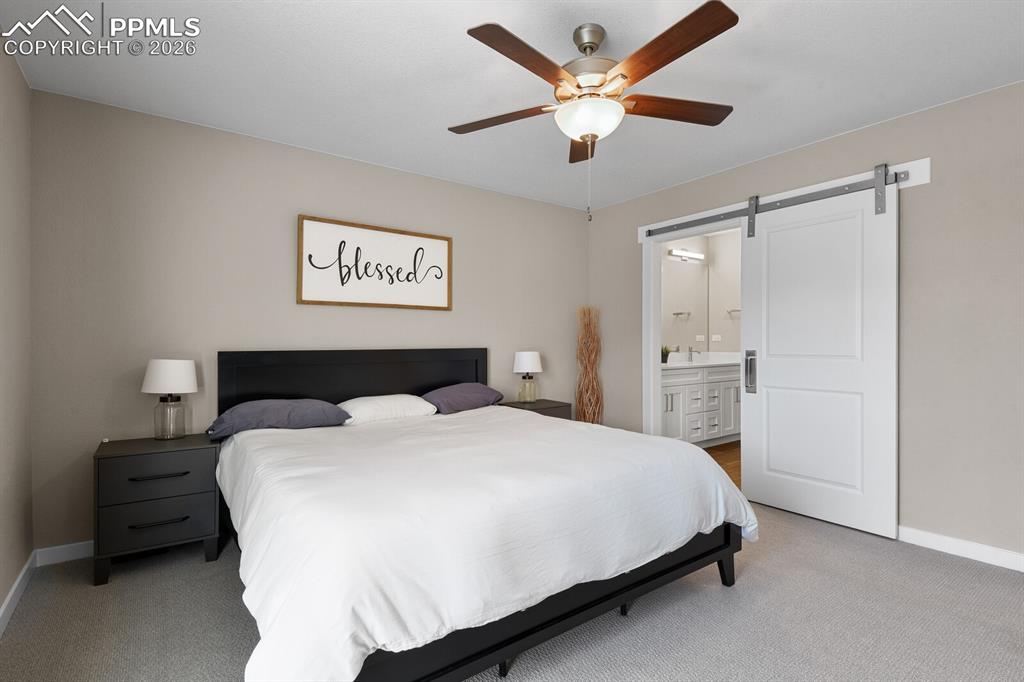Primary Suite With Barn Door Into Bath
