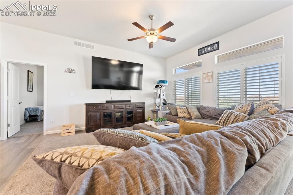 Living room which connects to the kitchen and primary suite